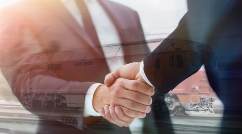 Handshake zweier Personen als Overlay über eine fahrende Lokomotive